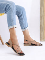 Zaysoo women's beige synthetic leather criss-cross strap flat sandals with back strap and metallic ornament.