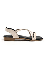 Zaysoo cream synthetic leather criss-cross strap flat sandals with back strap and metallic ornament.