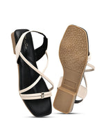 Zaysoo women's cream and black criss-cross strap flat sandals with a small heel and metallic detail.