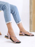 Zaysoo women's pink synthetic leather criss-cross strap flat sandals with back strap and metallic ornament.