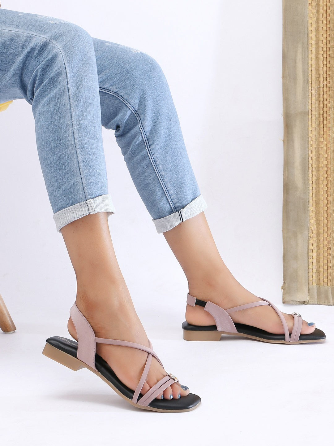 Zaysoo women's pink synthetic leather criss-cross strap flat sandals with back strap and metallic ornament.